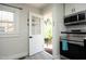 Open white door leading to the backyard and the stainless steel appliances at 1015 Washington St, Burlington, NC 27217