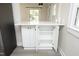 Kitchen island has shaker cabinets, pull out shelving and a white countertop at 1015 Washington St, Burlington, NC 27217