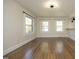 Bright living room with hardwood floors, large windows, and a cozy bar area, ideal for gatherings at 1015 Washington St, Burlington, NC 27217