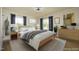 Serene main bedroom featuring soft lighting, large windows, and neutral tones for a relaxing retreat at 1015 Washington St, Burlington, NC 27217