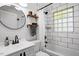 Bright bathroom features a modern vanity, subway tile, and a glass-block window for added privacy at 1017 Southerlund Rd, Garner, NC 27529