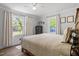 Relaxing bedroom boasts natural light from multiple windows, offering tranquil views of the outdoors at 1017 Southerlund Rd, Garner, NC 27529