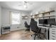 Versatile bedroom currently used as an office with a built-in desk and storage shelves at 1017 Southerlund Rd, Garner, NC 27529