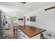 Bright kitchen features an island with wood countertop and sleek black hardware, with stainless steel appliances at 1017 Southerlund Rd, Garner, NC 27529