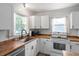 Bright, white kitchen with butcher block countertops and stainless steel appliances at 1017 Southerlund Rd, Garner, NC 27529