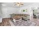 Comfortable living room featuring a fireplace, large windows, and an oversized couch at 1017 Southerlund Rd, Garner, NC 27529