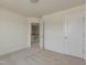 Cozy bedroom with neutral carpet and a doorway to the stairs provides ample space at 1028 Channel Drop Lp, Zebulon, NC 27597