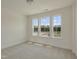 Sun-filled bedroom features carpet, three windows, and an airy feel at 1028 Channel Drop Lp, Zebulon, NC 27597