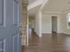 Inviting home foyer featuring wood-look floors, an open staircase, and plenty of natural light at 1028 Channel Drop Lp, Zebulon, NC 27597