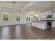 Open concept kitchen boasts a large island with bar seating, stainless appliances, and lots of natural light at 1028 Channel Drop Lp, Zebulon, NC 27597