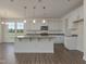 Modern kitchen featuring an island, stainless appliances, ample counter space, and tons of natural light at 1028 Channel Drop Lp, Zebulon, NC 27597