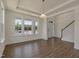 Bright and airy living room with natural light, wood floors, and staircase access at 1028 Channel Drop Lp, Zebulon, NC 27597