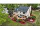 Aerial view showcasing a home with a spacious deck, mature landscaping, and lush greenery at 1053 Loop Rd, Clayton, NC 27527