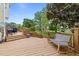 Expansive back deck with comfortable seating, grill, and stairs leading to the yard at 1053 Loop Rd, Clayton, NC 27527