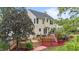 Spacious backyard featuring an expansive deck, lush greenery, and beautiful landscaping at 1053 Loop Rd, Clayton, NC 27527