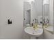 Cozy bathroom featuring a pedestal sink, and decorative wall mirror at 1053 Loop Rd, Clayton, NC 27527