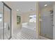 Bright bathroom with a soaking tub, walk-in shower and a serene backyard view at 1053 Loop Rd, Clayton, NC 27527