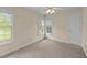 Inviting bedroom with two windows, plush carpet, and ample natural light at 1053 Loop Rd, Clayton, NC 27527