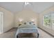 Bright bedroom with vaulted ceiling, plush carpet, and a large window overlooking the yard at 1053 Loop Rd, Clayton, NC 27527
