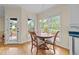 Bright breakfast nook with a round wooden table and views of the backyard at 1053 Loop Rd, Clayton, NC 27527