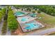 Aerial view of community pool with play structures, surrounded by lush trees and homes at 1053 Loop Rd, Clayton, NC 27527