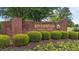 Riverwood Golf Club brick signage surrounded by manicured hedges and vibrant flowers at 1053 Loop Rd, Clayton, NC 27527