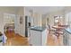 Well-lit kitchen featuring an island, stainless steel refrigerator, and hardwood floors at 1053 Loop Rd, Clayton, NC 27527