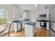 Functional kitchen with white cabinets, green countertops, and stainless steel appliances at 1053 Loop Rd, Clayton, NC 27527