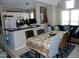 Open floor plan with dining room featuring a large table, breakfast bar, and lots of natural light at 1062 Washington St # 201, Raleigh, NC 27605