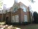 Brick townhome featuring multiple windows, neutral siding, landscaped lawn, and a covered doorway entrance at 1062 Washington St # 201, Raleigh, NC 27605