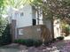 Brick townhome featuring multiple windows, neutral siding, landscaped lawn, and a covered entrance at 1062 Washington St # 201, Raleigh, NC 27605