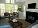 Living room with large window, plush sofa, decorative rug, fireplace, and charming accent chairs at 1062 Washington St # 201, Raleigh, NC 27605