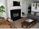 Living room featuring a fireplace, large window, sofas, decorative rug and charming accent chairs at 1062 Washington St # 201, Raleigh, NC 27605