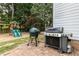 Lush backyard featuring various grills and an elevated playset with a climbing area and slides at 10709 Thornbury Crest Ct, Raleigh, NC 27614