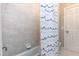 Tiled shower and tub combination, with a modern shower curtain, and clean design at 10709 Thornbury Crest Ct, Raleigh, NC 27614