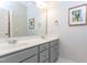Bathroom with double sink vanity, framed elephant art, and neutral color palette at 10709 Thornbury Crest Ct, Raleigh, NC 27614