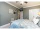 A comfortable bedroom featuring soft, blue bedding and neutral color scheme at 10709 Thornbury Crest Ct, Raleigh, NC 27614
