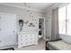 Bright bedroom with dinosaur wall decals, white dresser, and neutral tones at 10709 Thornbury Crest Ct, Raleigh, NC 27614