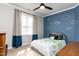 A cheerful bedroom with themed accent wall, comfortable bed, and natural light at 10709 Thornbury Crest Ct, Raleigh, NC 27614