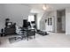 Bright bonus room featuring a desk, home office setup, and home gym equipment at 10709 Thornbury Crest Ct, Raleigh, NC 27614