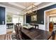 Dining room featuring a dark accent wall, a decorative light fixture, and a rustic dining table at 10709 Thornbury Crest Ct, Raleigh, NC 27614