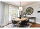 Charming dining area with oval table, modern pendant lighting, and large picture window at 10709 Thornbury Crest Ct, Raleigh, NC 27614