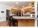 Beautiful kitchen with custom wood cabinets, stainless steel appliances, and breakfast bar seating at 10709 Thornbury Crest Ct, Raleigh, NC 27614