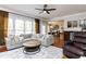 Inviting living room featuring a comfortable sectional sofa and stylish wood coffee table at 10709 Thornbury Crest Ct, Raleigh, NC 27614