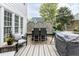 Inviting outdoor dining area on a wooden deck with privacy lattice and patio furniture at 10709 Thornbury Crest Ct, Raleigh, NC 27614