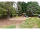 Large backyard play area with mulch bedding, a climbing dome, and a wooden swing set at 10709 Thornbury Crest Ct, Raleigh, NC 27614