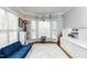 Bright and airy playroom featuring built-in storage, natural light, and a cozy blue sofa at 10709 Thornbury Crest Ct, Raleigh, NC 27614