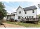 Spacious backyard featuring a deck, patio with a grill, and a playset with slides at 10709 Thornbury Crest Ct, Raleigh, NC 27614