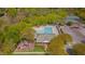 Aerial view showcasing the community pool, playground, and clubhouse surrounded by lush greenery at 109 Jones Creek Pl, Chapel Hill, NC 27516
