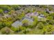 Community aerial view featuring tennis courts, pool, clubhouse, and parking nestled among mature trees at 109 Jones Creek Pl, Chapel Hill, NC 27516